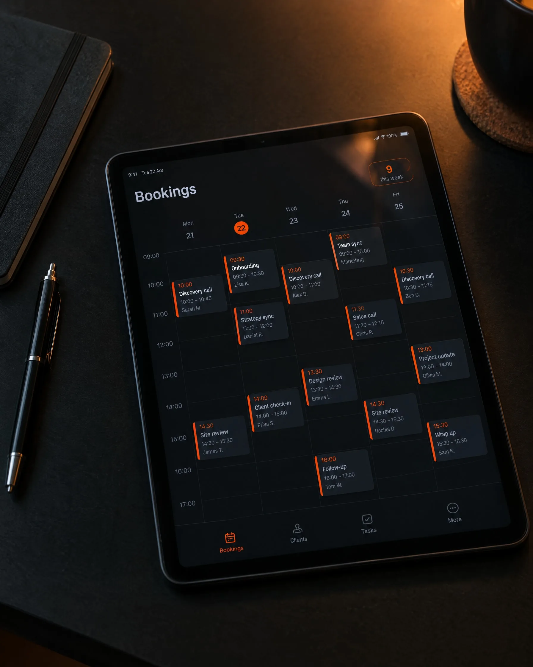 A tablet on a desk showing a weekly bookings calendar
